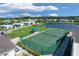 Aerial view of tennis courts and community landscape at 107 Tahitian Way, North Port, FL 34287