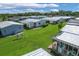 Aerial view of mobile home community with lush green lawns at 107 Tahitian Way, North Port, FL 34287