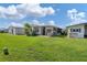 View of the home from the backyard showing neighboring homes at 107 Tahitian Way, North Port, FL 34287