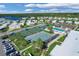 Aerial view of community with shuffleboard and tennis courts at 107 Tahitian Way, North Port, FL 34287