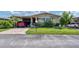 Well-maintained manufactured home with carport and landscaped lawn at 107 Tahitian Way, North Port, FL 34287
