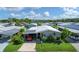 An aerial view of a mobile home with carport and landscaping at 107 Tahitian Way, North Port, FL 34287