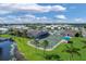 Aerial view of community pool, tennis courts, and clubhouse at 107 Tahitian Way, North Port, FL 34287