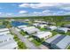 Mobile home community near a lake, featuring various homes at 107 Tahitian Way, North Port, FL 34287
