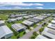 Bird's-eye view of a mobile home community near a lake at 107 Tahitian Way, North Port, FL 34287