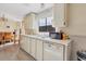 Functional kitchen with white cabinets and wood floors at 107 Tahitian Way, North Port, FL 34287