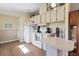 Bright kitchen with white cabinets and a breakfast bar at 107 Tahitian Way, North Port, FL 34287