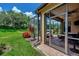 Landscaped backyard with a large screened patio at 20193 Pezzana Dr, Venice, FL 34292