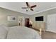 Spacious bedroom with a large bed, dresser, and TV at 20193 Pezzana Dr, Venice, FL 34292
