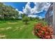 Private backyard with lush lawn and colorful flowers at 20193 Pezzana Dr, Venice, FL 34292