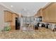 Well-equipped kitchen featuring granite countertops and breakfast nook at 20193 Pezzana Dr, Venice, FL 34292