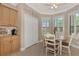 Bright breakfast nook with wood table and chairs, and built-in storage at 20193 Pezzana Dr, Venice, FL 34292