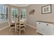 Charming breakfast nook with a round table and four chairs, near a window at 20193 Pezzana Dr, Venice, FL 34292