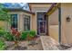 Brick walkway to screened entry of tan house at 20193 Pezzana Dr, Venice, FL 34292