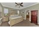 Main bedroom with a king-size bed and attached bathroom at 20193 Pezzana Dr, Venice, FL 34292