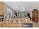 Eat-in kitchen with double sink, granite countertops, and ample cabinetry at 20193 Pezzana Dr, Venice, FL 34292