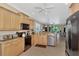 Open kitchen with island, stainless steel appliances, and granite countertops at 20193 Pezzana Dr, Venice, FL 34292