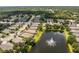 Aerial view of a house near a lake with fountain at 24849 Pennington Ter, Venice, FL 34293