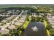 Aerial view of houses and lake with fountain at 24849 Pennington Ter, Venice, FL 34293