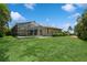 Large backyard with lush lawn, screened pool and patio at 612 Albee W Rd, Nokomis, FL 34275