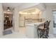 Kitchen with breakfast bar, white cabinets and view of dining area at 612 Albee W Rd, Nokomis, FL 34275