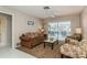 Bright living room with pool view, comfy seating and access to a screened lanai at 612 Albee W Rd, Nokomis, FL 34275