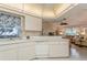 Well-lit kitchen with white cabinets, ample counter space and appliances at 612 Albee W Rd, Nokomis, FL 34275