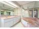 Large bathroom with double sinks, bathtub, and separate shower at 612 Albee W Rd, Nokomis, FL 34275