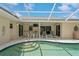 Screened pool area with patio furniture and pool steps at 612 Albee W Rd, Nokomis, FL 34275