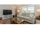 Living room with comfy seating and a large TV at 612 Albee W Rd, Nokomis, FL 34275