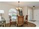 Bright dining room featuring a glass table and four chairs at 612 Albee W Rd, Nokomis, FL 34275