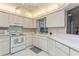 Kitchen features white cabinets, ample counter space and appliances at 612 Albee W Rd, Nokomis, FL 34275