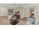 Comfortable living room featuring a sofa and built-in shelving at 1411 Strada D Argento, Venice, FL 34292