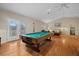 Game room with pool table and hardwood floors at 8188 Shadow Pine Way, Sarasota, FL 34238