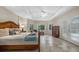 Spacious bedroom with a king-size bed and access to a pool at 8188 Shadow Pine Way, Sarasota, FL 34238