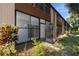 View of condo building showcasing the screened patios and landscaping at 4 Quails Run Blvd # 5, Englewood, FL 34223