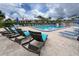 Relaxing community pool area with ample lounge chairs and patio space at 4 Quails Run Blvd # 5, Englewood, FL 34223