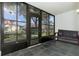 Relaxing screened patio with tiled floor and bench, offering a view of the surrounding landscape at 4 Quails Run Blvd # 5, Englewood, FL 34223