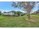 Spacious backyard with a view of the house and surrounding landscape at 9155 Coachman Dr, Venice, FL 34293