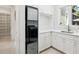 Modern laundry room with white cabinets and new appliances at 1040 Gulf Winds Way, Nokomis, FL 34275