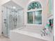 Spa-like bathroom with a walk-in shower and soaking tub at 1040 Gulf Winds Way, Nokomis, FL 34275