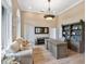 Bright home office features built-in shelving, large windows, and comfortable seating at 1040 Gulf Winds Way, Nokomis, FL 34275