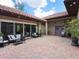 Charming courtyard with brick pavers and relaxing seating area at 1040 Gulf Winds Way, Nokomis, FL 34275