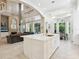Open concept kitchen with large island, white cabinetry, and breakfast area at 1040 Gulf Winds Way, Nokomis, FL 34275