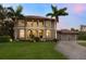 Mediterranean style home with three-car garage at dusk at 1040 Gulf Winds Way, Nokomis, FL 34275