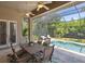 Covered patio with dining area overlooking a refreshing pool at 1040 Gulf Winds Way, Nokomis, FL 34275