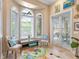 Peaceful sitting area with bay windows and a colorful rug at 1040 Gulf Winds Way, Nokomis, FL 34275