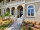 Grand house entrance with arched entryway and landscaping at 1040 Gulf Winds Way, Nokomis, FL 34275