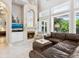 Bright living room with a fireplace and comfortable seating at 1040 Gulf Winds Way, Nokomis, FL 34275