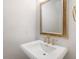 Simple bathroom with pedestal sink and ornate mirror at 1040 Gulf Winds Way, Nokomis, FL 34275